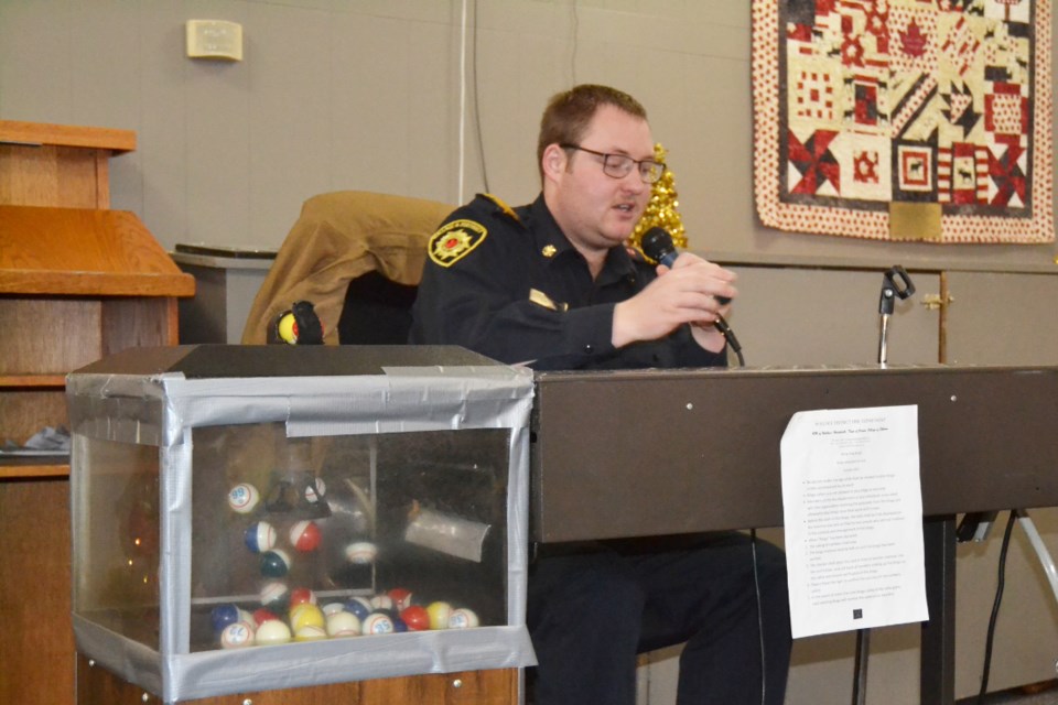  Wallace District Fire Chief Tyson Van Eaton calls out numbers during a bingo game