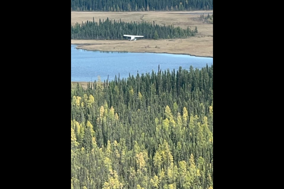 The downed plane is seen in a boggy area near Red Sucker Lake.