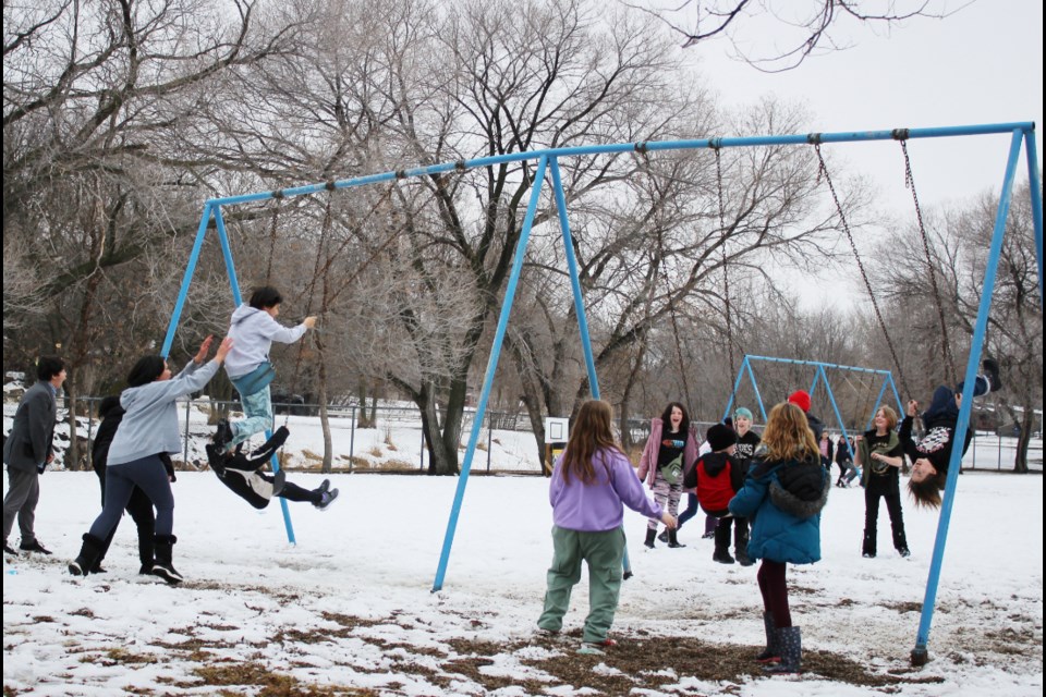 Virden Junior High students appear to relish their outdoor break on Feb. 5, a +3degree afternoon. Some swing as high as they can possibly go, while elsewhere groups of kids are on a play structure or roaming the playground before the buzzer goes to call them back to classroom work.