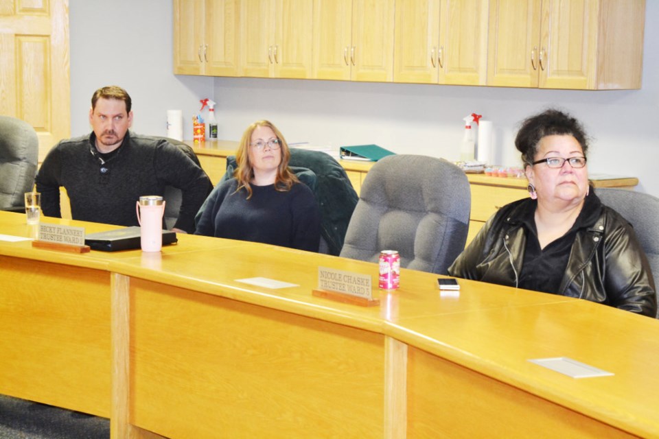 Mark Johnston, Supervisor of Operations for Fort La Bosse School Division, Ward 2 Trustee Becky Flannery and Ward 5 Trustee Nicole Chaske watch the screen in the division's boardroom during the annual public budget consultation meeting on Mar. 8. PHOTO/LINDSAY WHITE