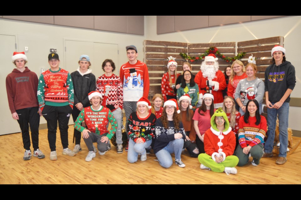 The Breakfast Crew - Virden Collegiate Grade 12 students pose for a photo with Santa Claus.
