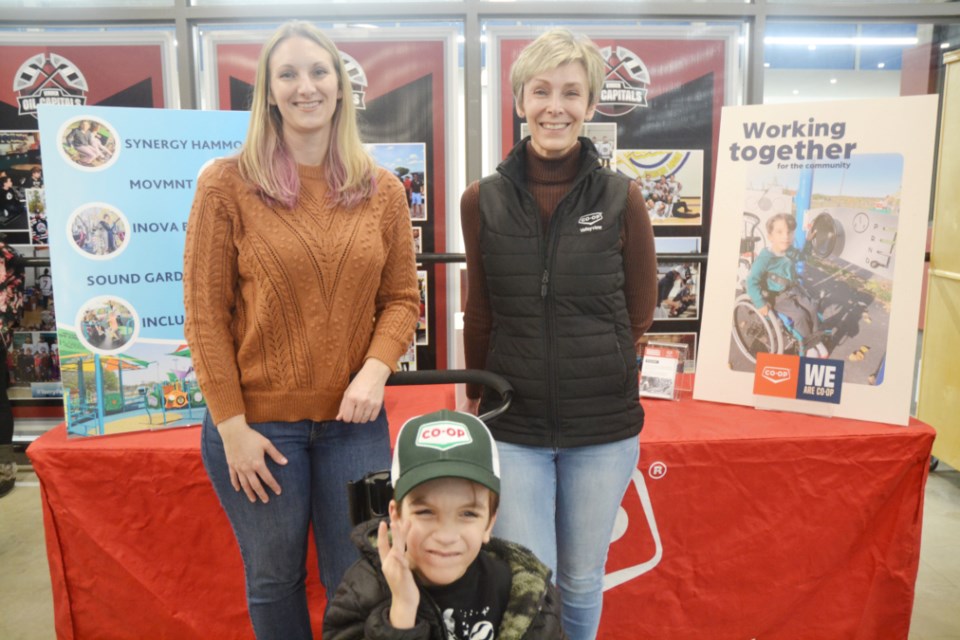 Mary Montgomery School student Nixon Gray with his mom Andrea (l) and, for Valleyview Consumers Co-op,  Amber Vandaele at the Oil Caps game at TOGP, March 15. 