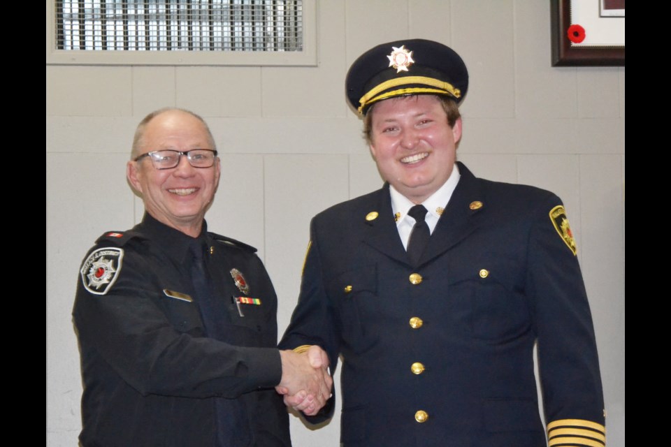 Wallace District Fire Department Chief Tyson Van Eaton, right, congratulates Curtis Smith on his over four decades in the fire service. Smith has been a firefighter since 1979, serving on both the Virden and Killarney departments.   