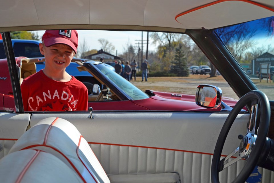 Dylan Tapp of Hargrave checks out a restored 1972 Chevrolet Monte Carlo coupe displayed by Bev Collier of Virden. Collier took part in the Westman on Wheels auto parade on Thanksgiving Sunday, Oct. 10.
