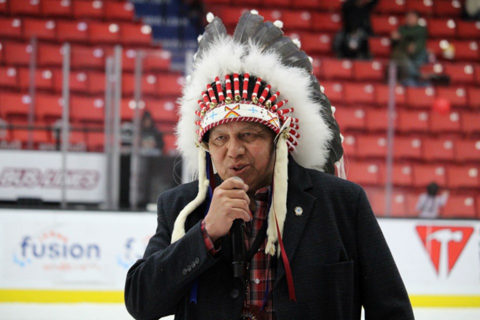 In ceremonial headdress, Sioux Valley Dakota Nation Chief Vince Tacan speaks at the Friday evening opening ceremonies. 