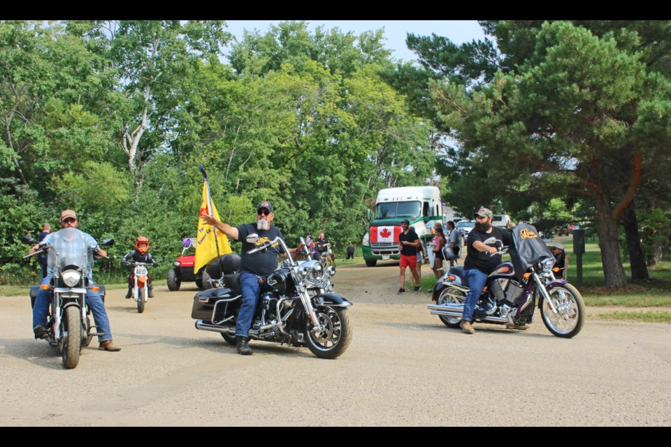 Memorial riders Justin Decroliere (r), Dennis Griffith  and Tanner Decroliere (l) in the Oak Lake parade on July 22.