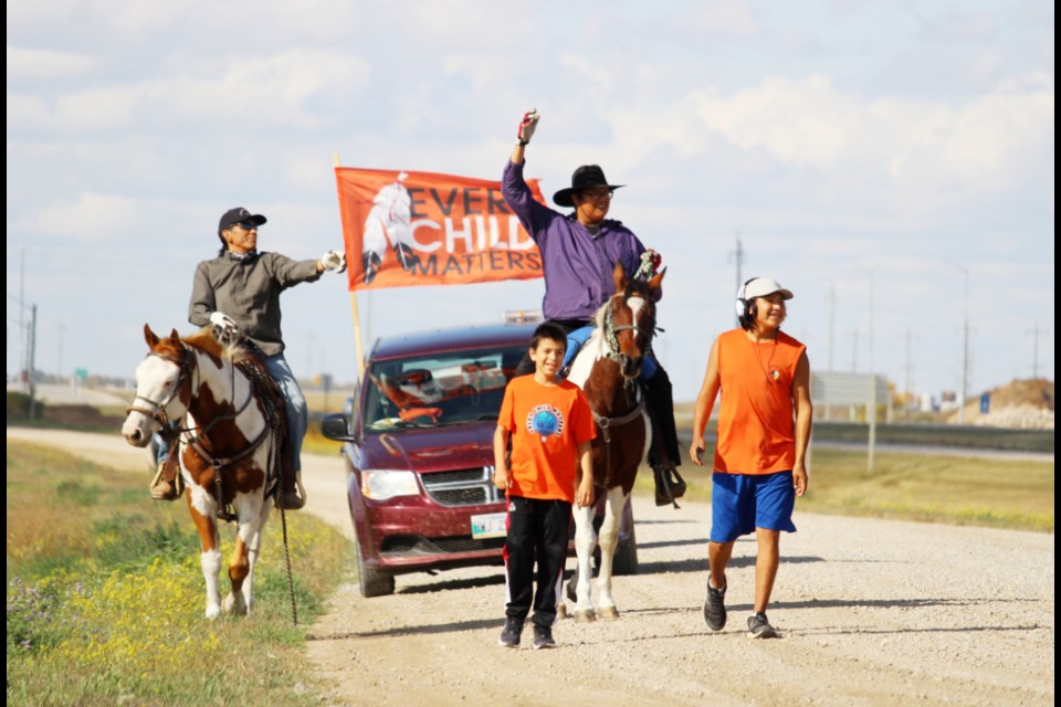 After their visit to the site of the former Elkhorn Residential School, brothers Ronan Saulteaux (l) and Tao Moody of Birdtail lead riders Gabriel Sutherland (l) and Morgan Redman on the next leg of the 2023 Every Child Matters Ride.