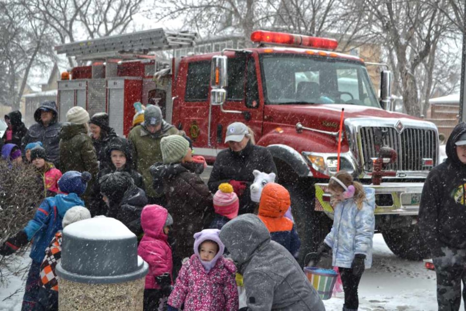 Youngsters brave the cold and snow in search of eggs during the first annual Wallace District Fire Department Easter Egg Hunt in Victoria Park on Easter Sunday.