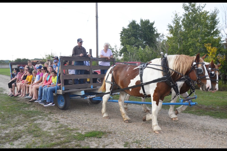 Ken and Audrey Jasper, who reside near Hartney, take visitors for a hayride around the community during the Harvest Festival in Oak Lake on Sept. 10. 