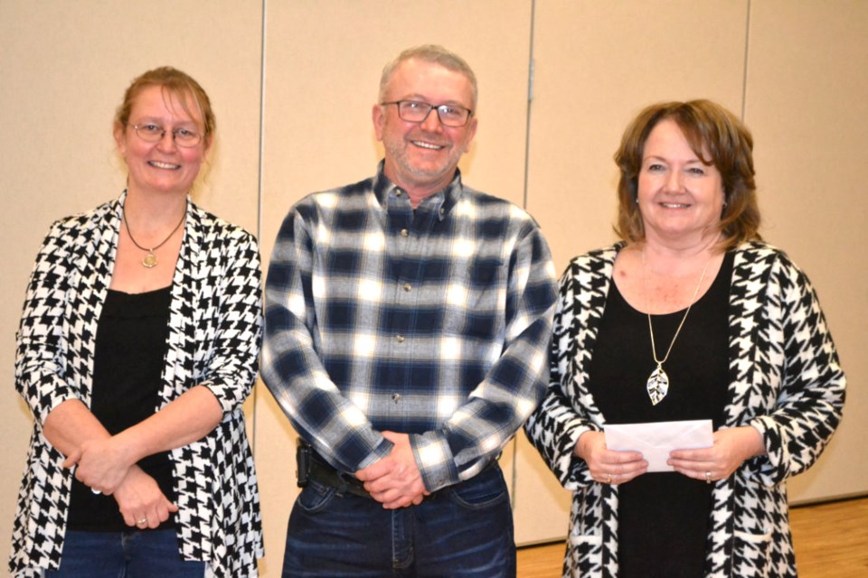 Town of Virden Public Works Foreman Maurice Kernel receives his 35-year of service award from Chief Administrative Officer Rhonda Stewart, right, and Mayor Tina Williams, at the Town's Christmas Banquet on December 3.