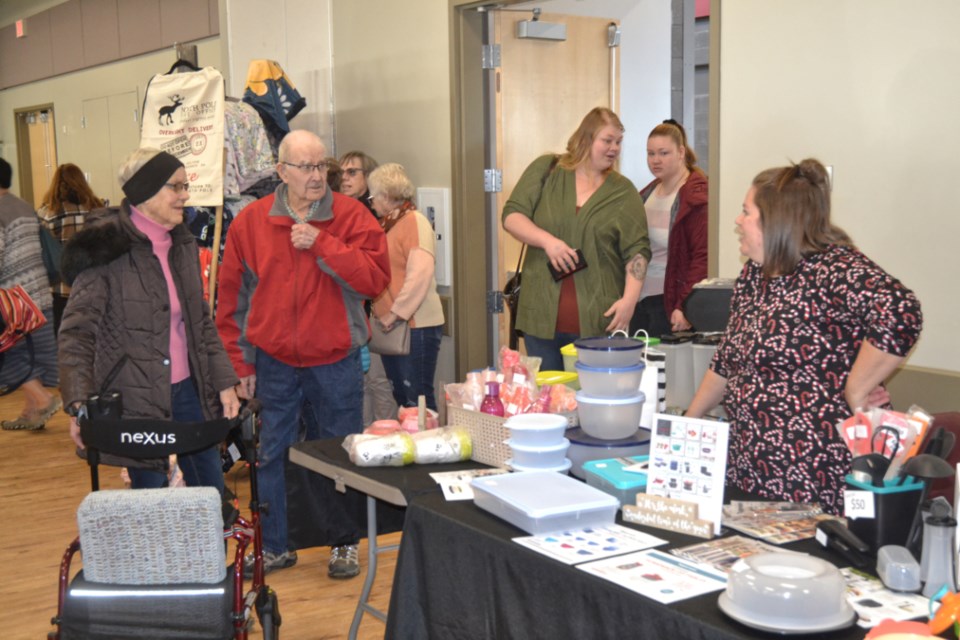 Organizer Tracy Landels, right, greets visitors to the Splash of Christmas Craft & Trade Show. Landels is a Tupperware representative and displays a variety of the company's products