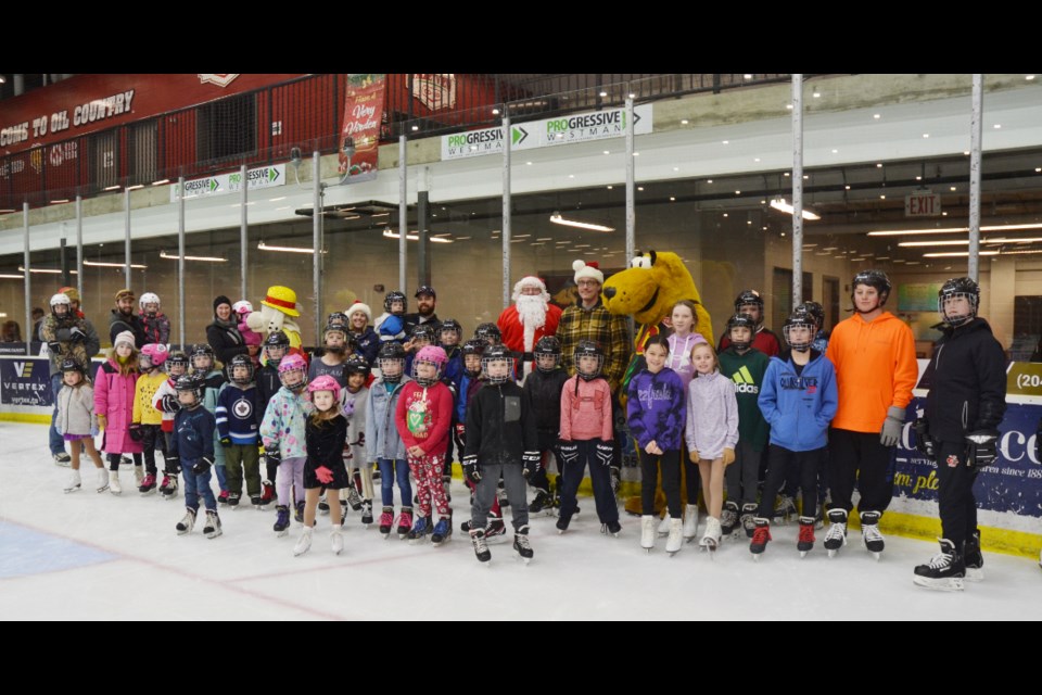 Some of the participants gather for a photo with Sparky, the Wallace District Fire Department mascot (l), Santa Claus and Cooper, the Valleyview Consumers Co-op mascot.