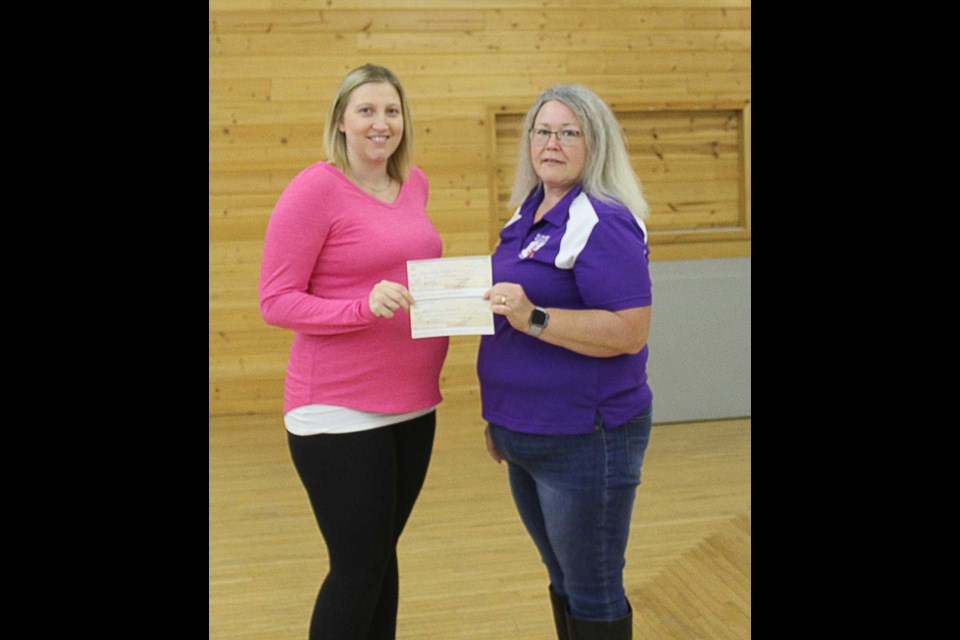 Cassidy Howard (Elkhorn Park Revitalization Project committee) accepts a donation from Wanda Rhodes (Elks President).