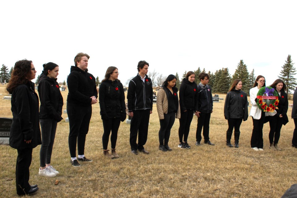 Reston Gr. 11& 12 class stand in a semicircle during the short service of Remembrance..