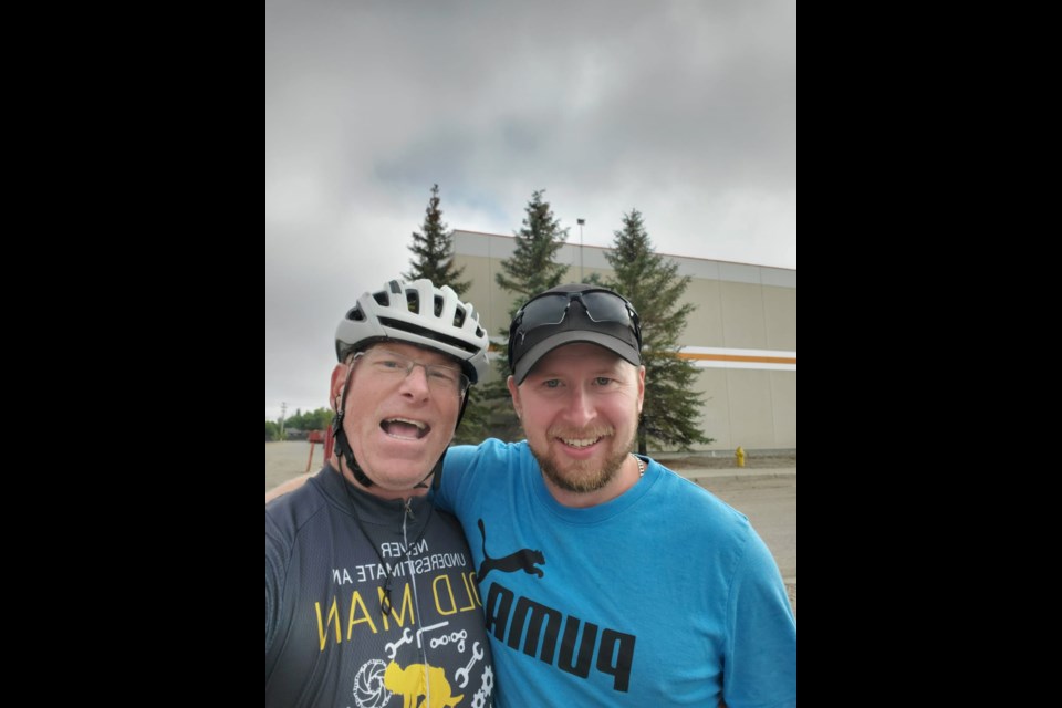 Nederlof's former neighbor from Wawanesa, recently posted to Regina, meets Nederlof (left) on the road.