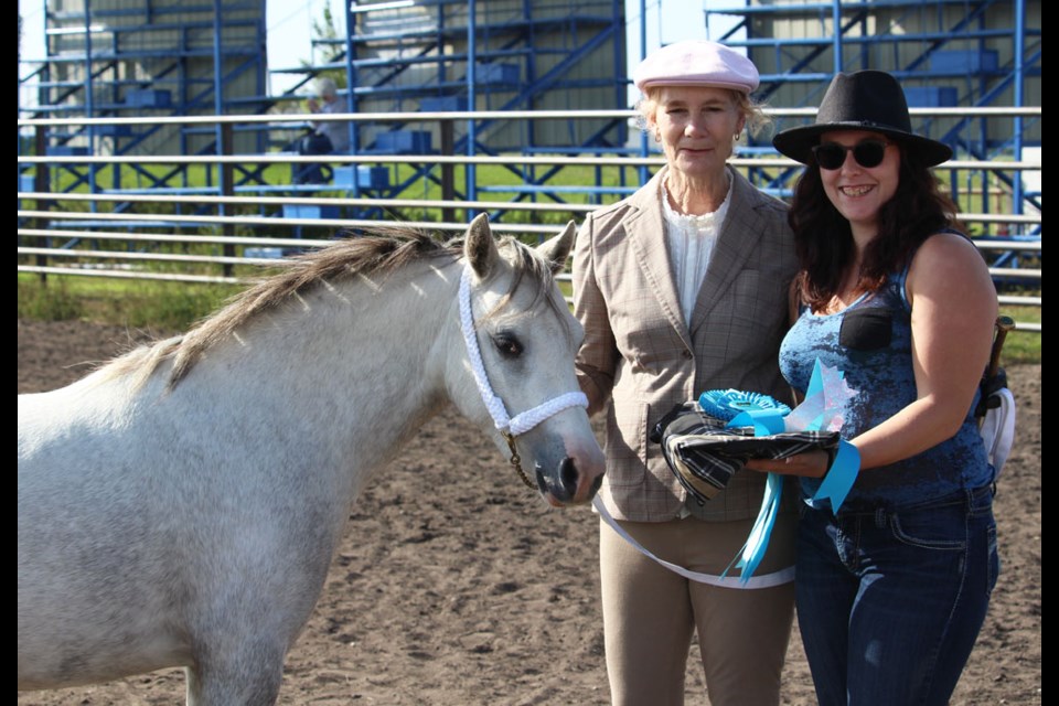 Alberta Welsh breeder Brenda Harder and her young pony awarded following a line class. Brenda, originally from Crandall, Man. got her start in the Welsh pony breed here.