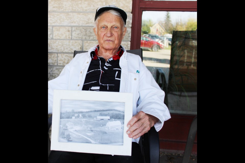 Ken Wardle, a resident of Princess Lodge with the photo of the Wardle farm where he grew up, nine miles west of Virden.