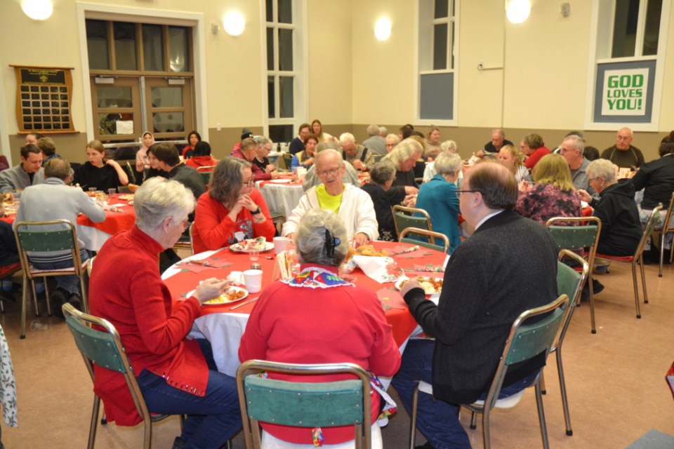 Guests of the St. Mary's Anglican Church Christmas Day Dinner enjoy their festive meal and fellowship on Dec. 25.