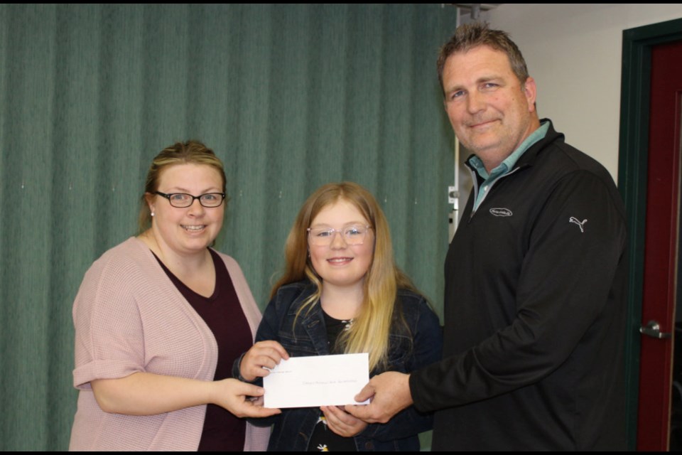 Cory Barkley presents  Elkhorn Memorial Park Revitalization project, represented by Allison Volk and daughter Khloe, with $5,000.