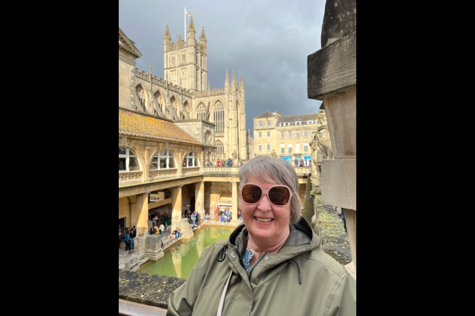 Linda Clark at Bath, UK, the Roman baths in the background and the abbey where she attended the Maundy Thursday church service.