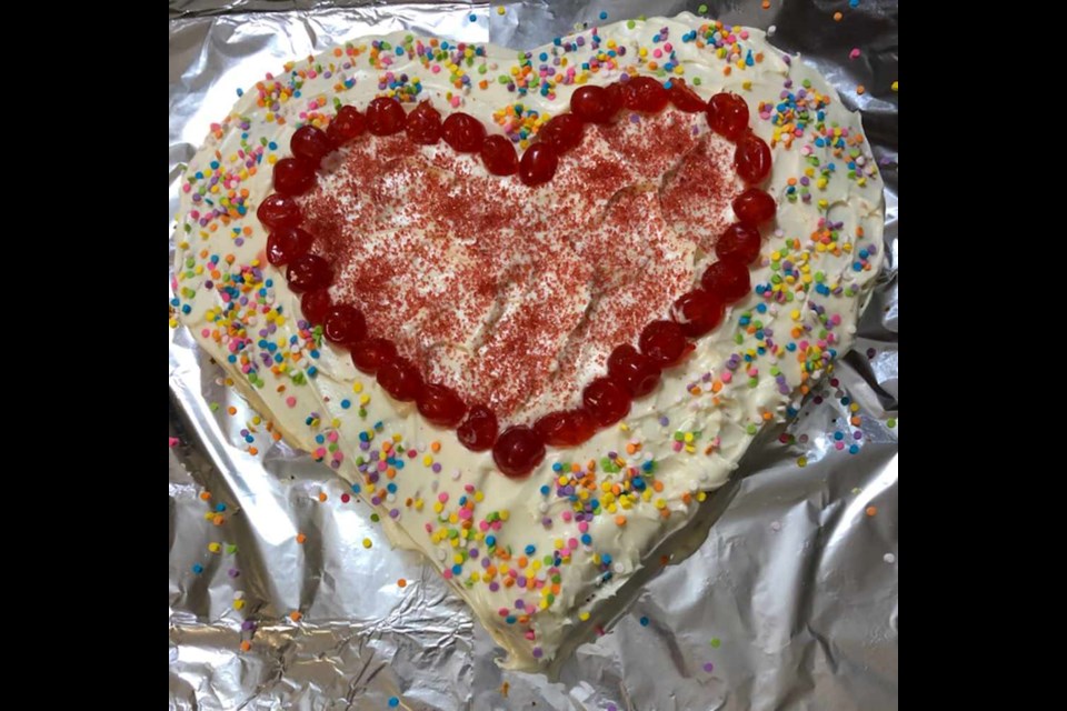 You get your Valentine shape by using a square cake pan and a round pan. Cut the round cake in half and put the pieces on two sides of the square pan. Decorate as you please.