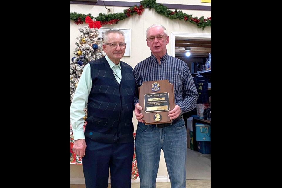 Lion Jim Tapp receives the Melvin Jones Fellowship Award and plaque, the highest award a Lion can get at the Club level; (l-r) Lion Alex Grieve and Lion Jim. 