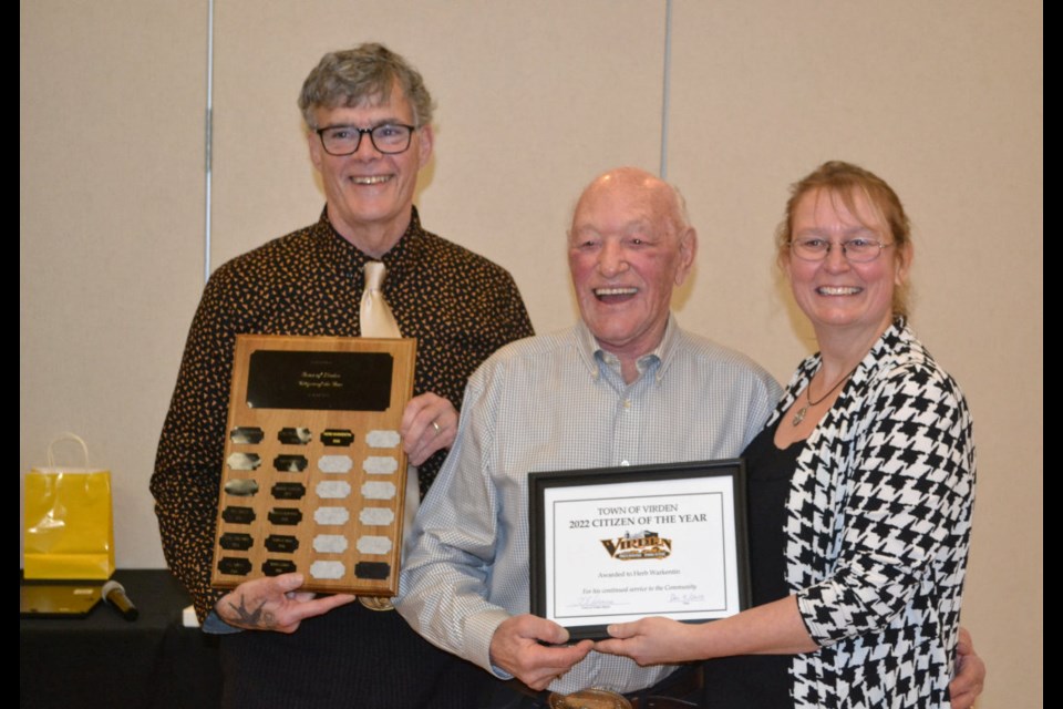 Herb Warkentin receives the 2022 Town of Virden Citizen of the Year Awarded during the town's annual Christmas Banquet. Deputy Mayor Marc Savy (l) and Mayor Tina Williams present the plaque and commemorative name plaque.