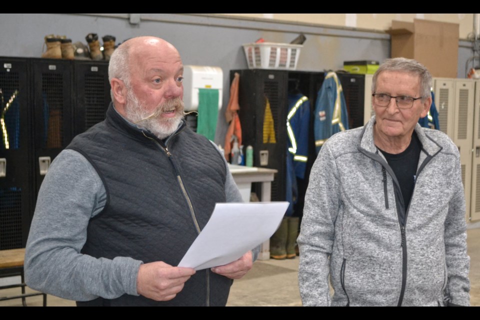 Dennis Day (l) owner of Fontana's Trucking of Virden, speaks to co-workers, customers, family and friends gathered for a luncheon in recognition of Bruce Bailey on Dec. 15. Bailey retired from the company in December after 39 years of service. 