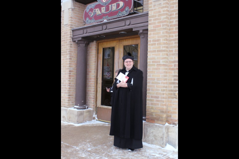 Fr. Matt Koovisk awaits the Remembrance Day processional at the doors of Virden's Aud Theatre in 2017.