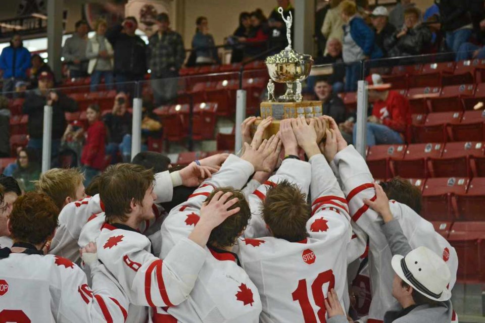 Notre Dame Hounds players hoist the championship trophy after winning the final game of the Telus Cup Western Regionals.