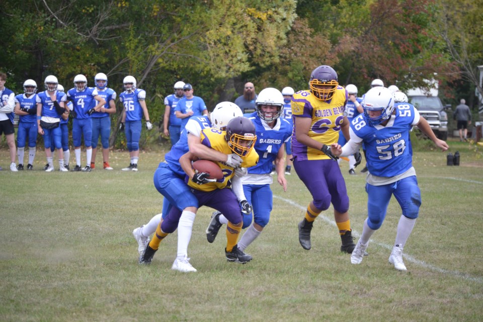Virden Collegiate Golden Bears Luka Mahmutavich is tackled by the Sabres #50 Kai Bennett on home turf during the second half of the Bears' season opener on Sept. 10. 
