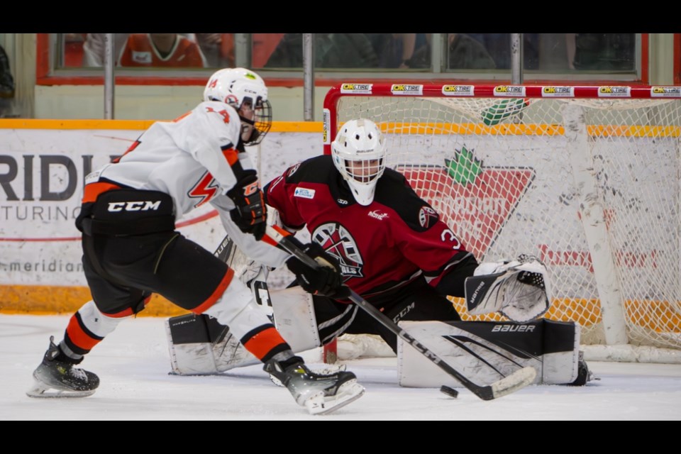 At the final home game in the second round finals series, Oil Capitals goalie Eric Reid is focused on shutting down the shot from Winkler Flyers forward.