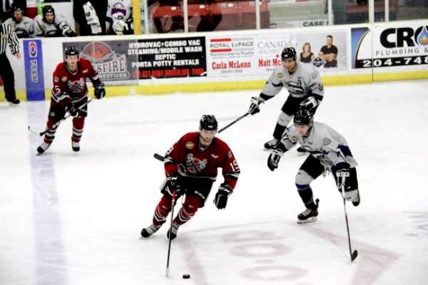 Bryden Keisman #19; and Trevor Hunt #5 move the puck down the ice.