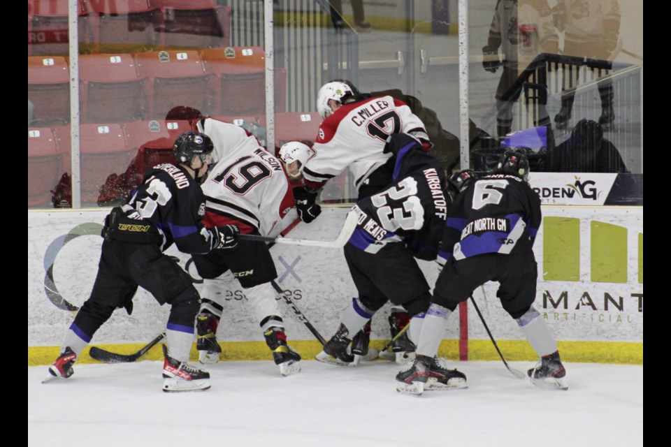 Brody Wilson and Colten Miller work to free the puck in an early April game, in the first round series against OCN Blizzard.  