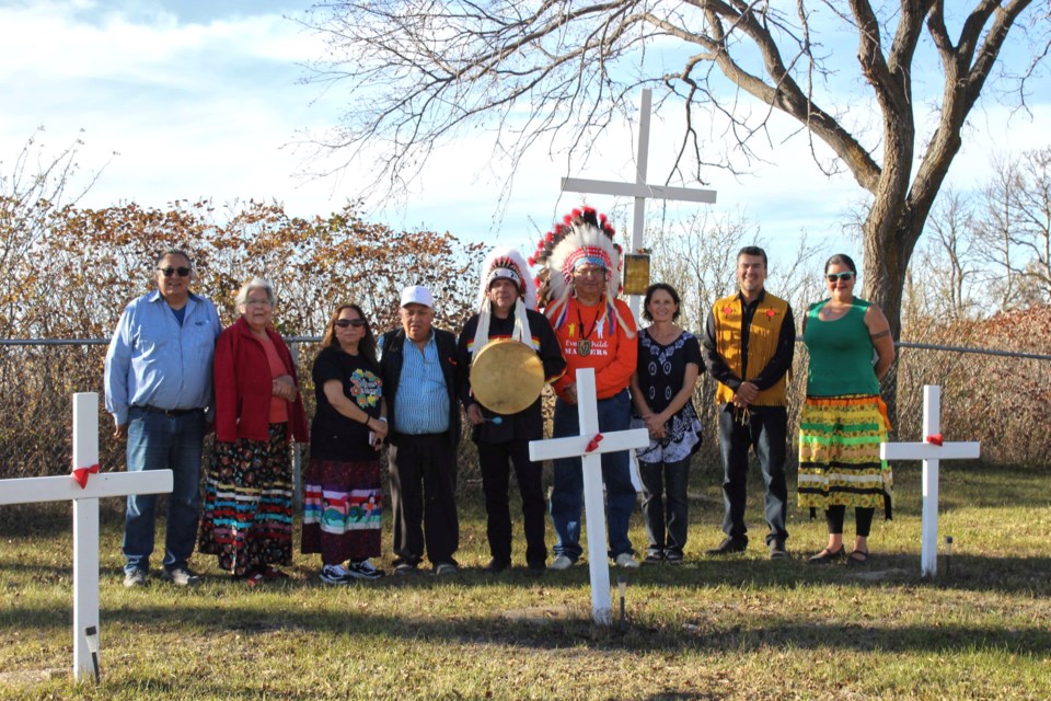 At the Elkhorn Residential School cemetery west of town (l-r): Spiritual leader Elder Stan LaPierre (Roseau River), Elder Rebecca Ross (Pimicikamak Cree Nation), Dr. Violet and Rudy Okemaw (Winnipeg), Garrison Settee (Grand Chief of Northern First Nations), Ken Whitecloud (a former chief, Sioux Valley), Alicia Hoemsen (Elkhorn), Ted Bland (York Factory) and Melanie Ferris (writer, MKO office). 