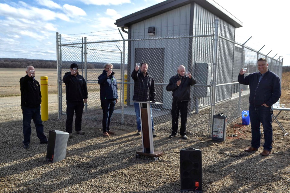 - CHEERS! Dignitaries taking part in the Grand Opening and Ribbon Cutting of the new Town of Virden water source and well site raise their glasses in a ceremonial toast October 25. PHOTO/LINDSAY WHITE