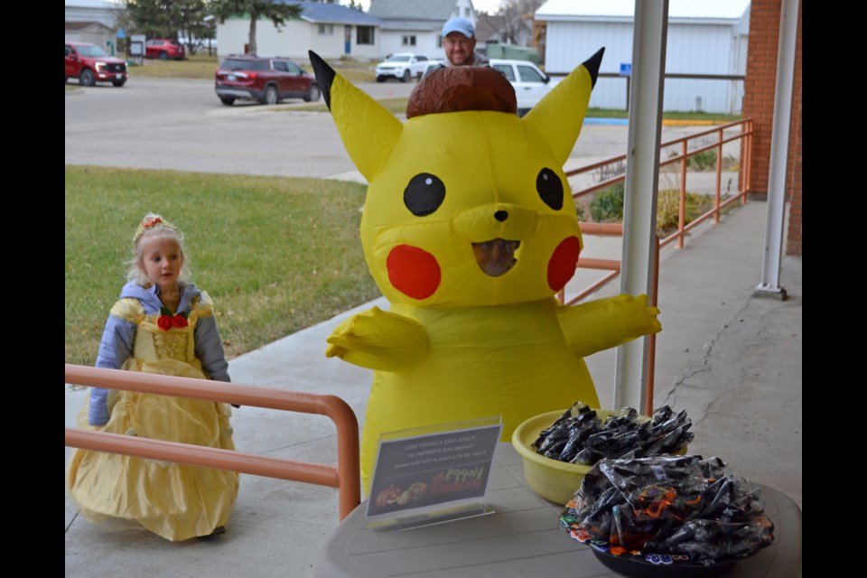  Nell (l) and Ben Renard pose in their Halloween costumes at The Sherwood on October 31.  Ben is dressed as the Pokemon character Pikachu.