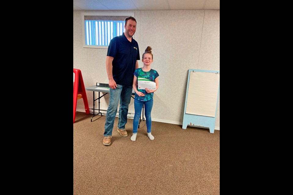 Curtis Wolters, leader of Virden 4H Variety Club, with Alivia Flannery on Achievement Day