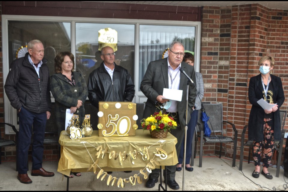 Dignitaries listen as Brian Schoonbaert, Chief Executive Officer of Prairie Mountain Health, brings greetings and reviews historical anecdotes of West-Man Nursing Home during the 50th Anniversary Celebration on a rainy September 23