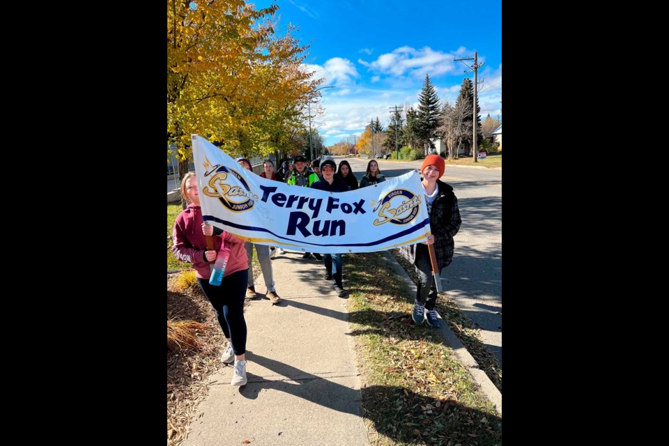 Virden Junior High students, Grades 5 – 8, are on their Terry Fox 6-kilometre walk, with Cody Sparwood, Andrea Walton, and Abi Torrance as banner bearers on this walk,