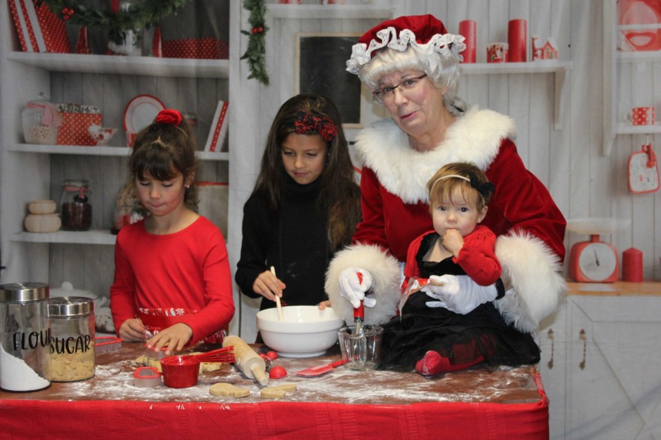 Members of the Bajus family with Mrs. Claus who was busy in the North Pole kitchen making cookies. 