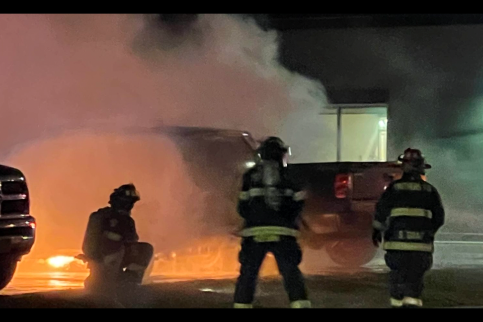 Firefighters battle an October arson blaze in Smithers, B.C. that destroyed or damaged eight vehicles including four RCMP vehicles and an ambulance. | Submitted 