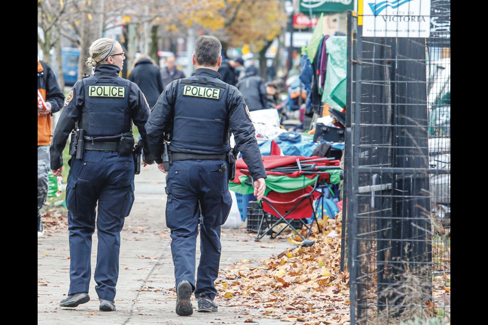 Victoria Police officers Mark Jenkins and Jess Moretto patrol the downtown area around Our Place which is known for its the drug and mental health issues. | Adrian Lam, Times Colonist